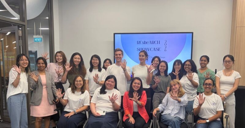 Participants hold up five fingers to celebrate the fifth anniversary of the ReSHEarch Showcase and SWE NTU