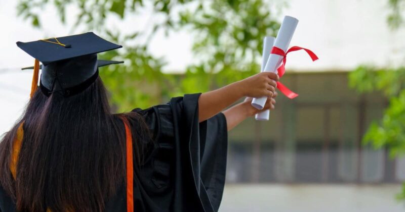 Stock photo of woman holding a diploma at Minority-Serving Institutions