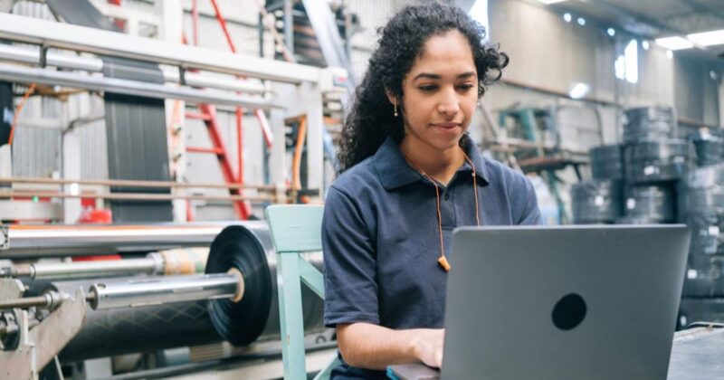 stock photo of a licensed woman engineer working on her laptop